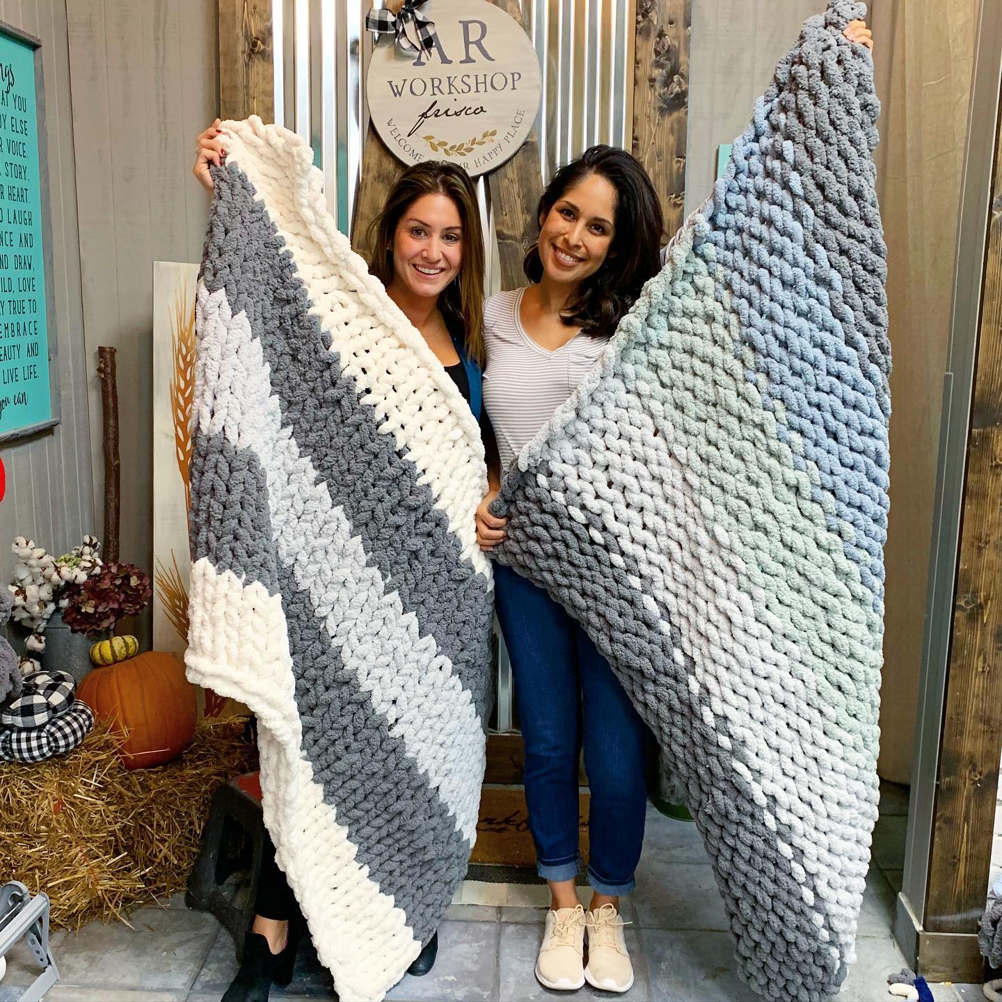 In AR Workshop, two happy ladies show off their crocheted blanket