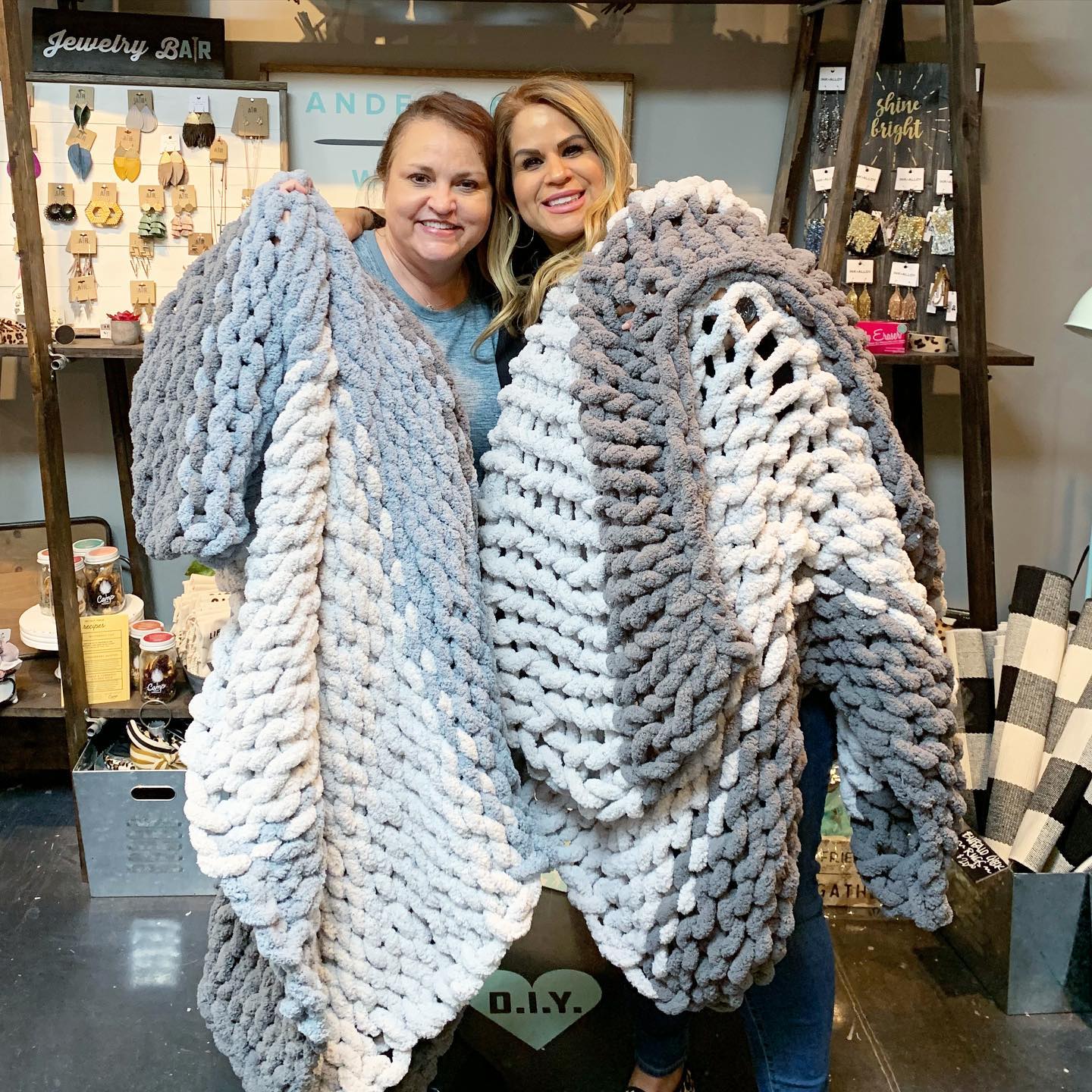In AR Workshop, two happy ladies show off their crocheted blanket