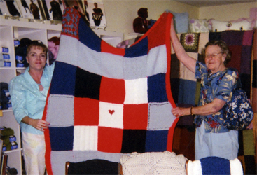 Debra (left) with the blanket given to the firehouse
