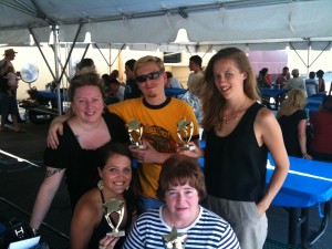The winning team in the trivia competition, They are holding their prizes.