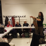 Shira teaches arm knitting to The Soundview Knitting Guild