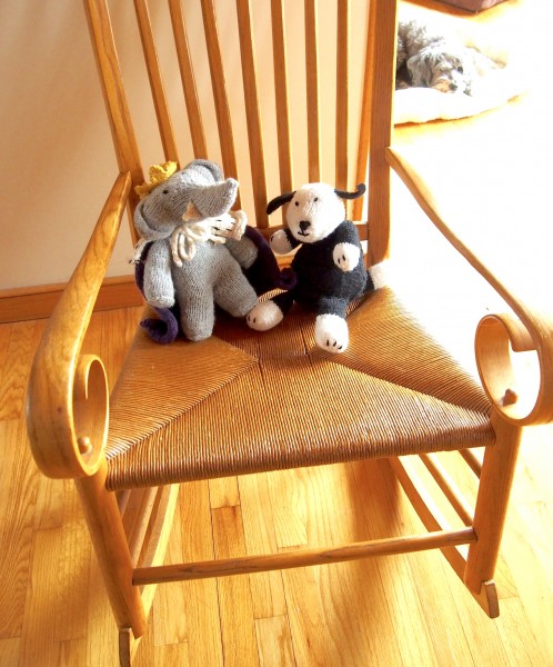 Babar and Sheep Dog are sitting on a chair