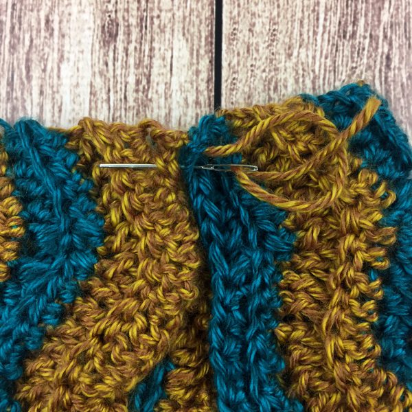 Cowl made in one piece and needle together
